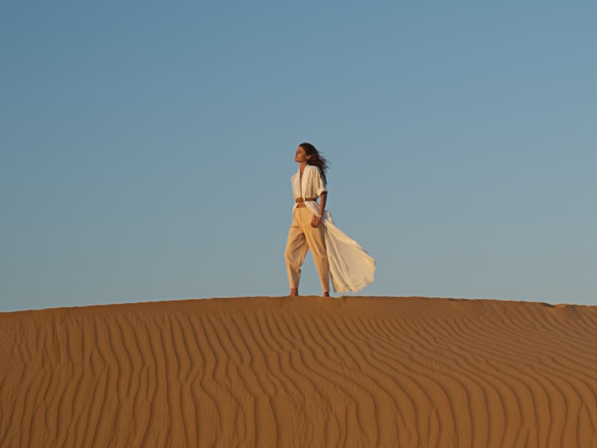 person standing on a sand dune